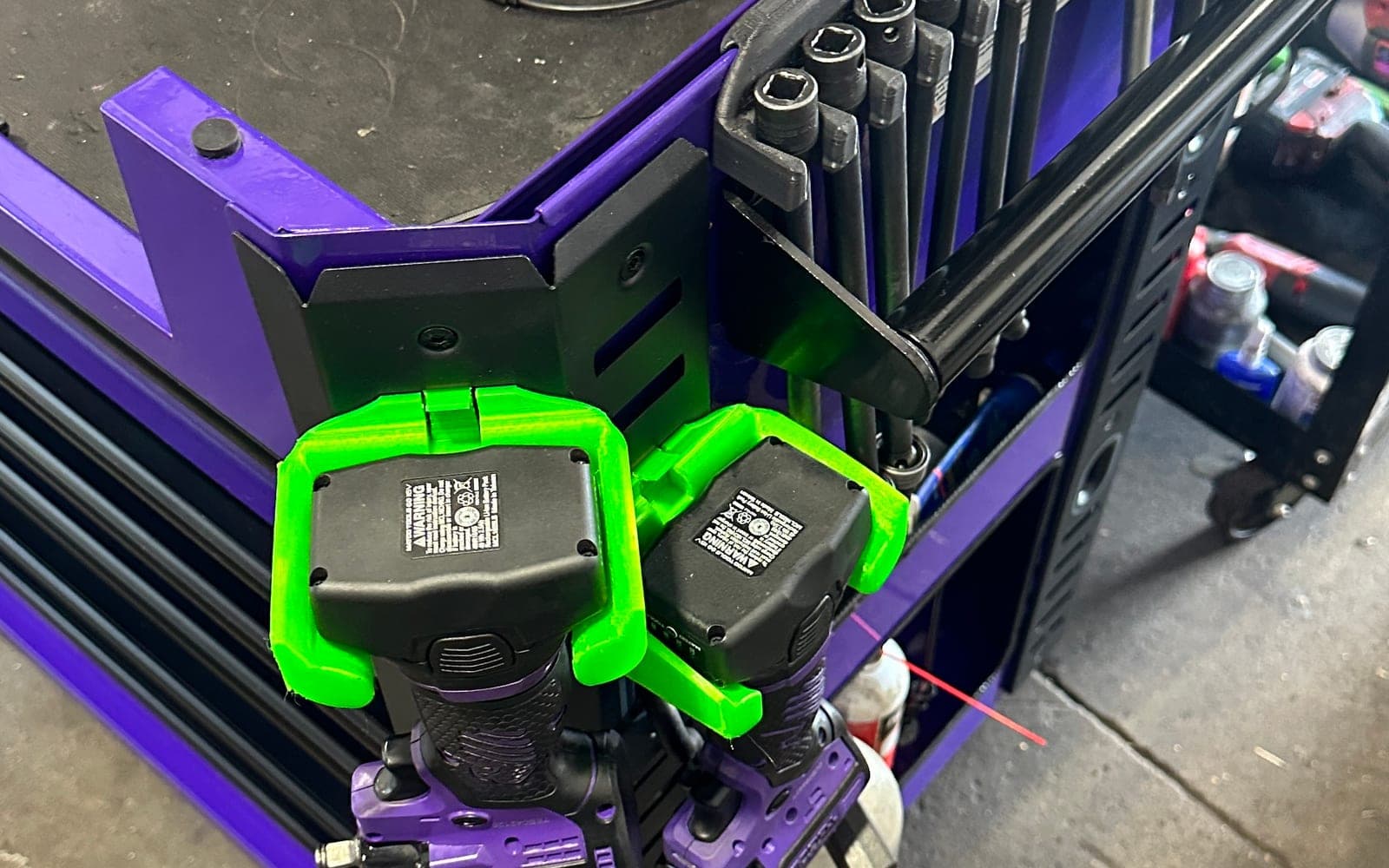 Bright green functional 3D printed tool holders mounted on a shop cart
