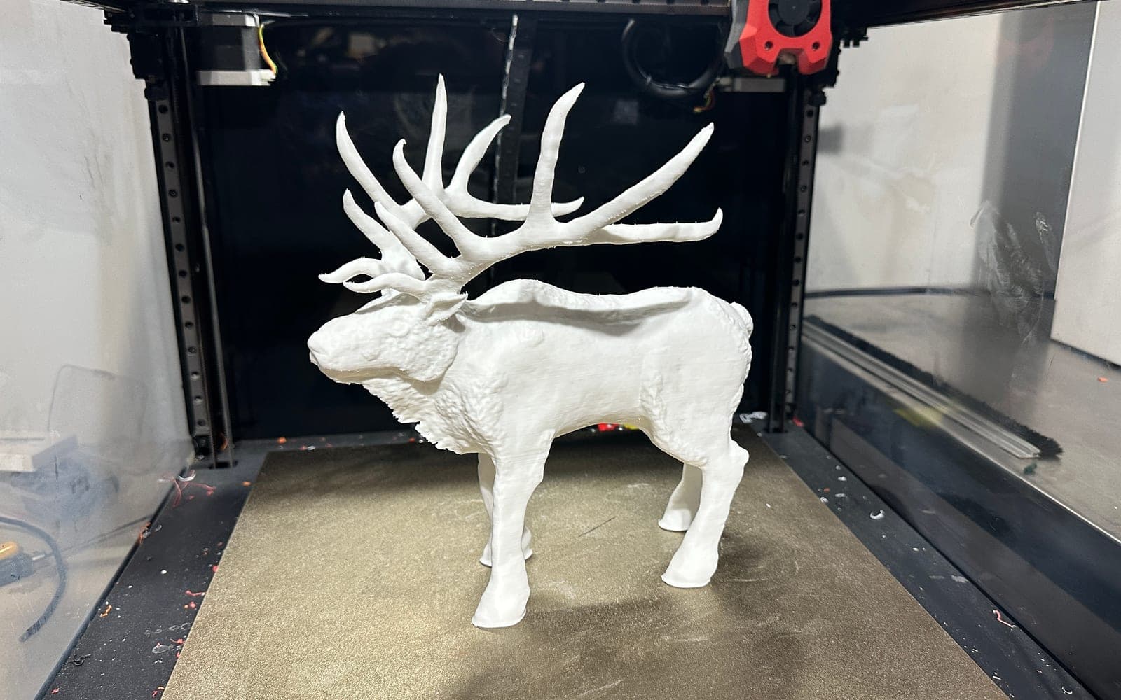 White 3D printed elk display model on a printer bed