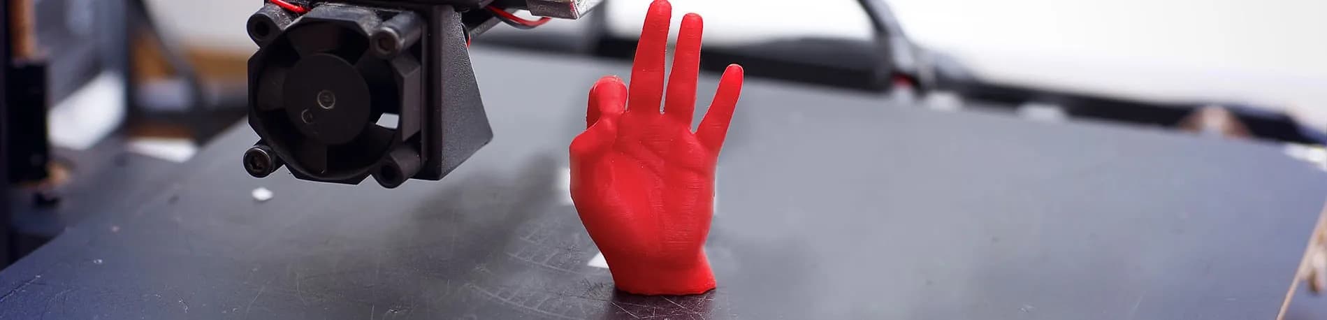 Small red 3D print on a printer bed for online quote review